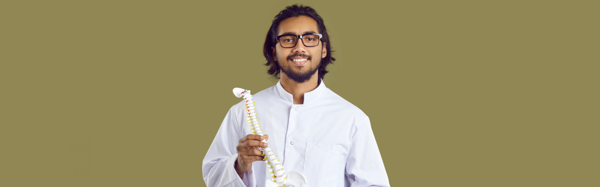 Male doctor holding a spinal cord figure portrait